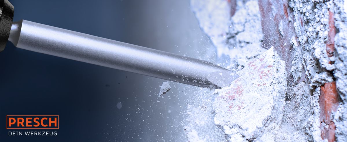 Presch Meißelset in Aktion beim Durchschlagen einer Mauer mit Staub und Splittern, hochwertiges Stemmeisen-Werkzeug.