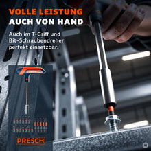 Hand dreht mit dem T-Griff Bithalter eine Schraube an einem Stahlträger fest