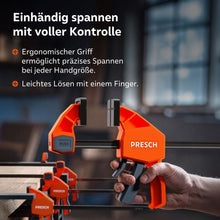 Detailaufnahme der Handhabung: Der ergonomische Griff der 150kg Zwinge ermöglicht ein präzises Kraftdosieren bei jeder Handgröße. Über einen kleinen Entriegelungshebel lässt sich die Spannung kontrolliert mit nur einem Finger wieder lösen.