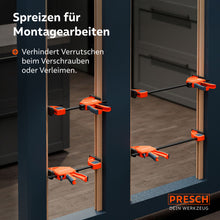 Einsatzbeispiel im Innenausbau: Mehrere 300kg Einhandzwingen werden im Spreizmodus genutzt, um einen massiven Holzrahmen während des Einbaus exakt auf Distanz zu halten und zu fixieren.