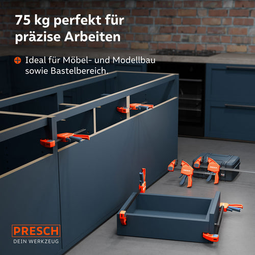 Anwendungsbeispiel im Möbelbau: Mehrere Einhandzwingen aus dem Set fixieren Korpus-Teile und eine Schublade während der Montage in einer Küche.