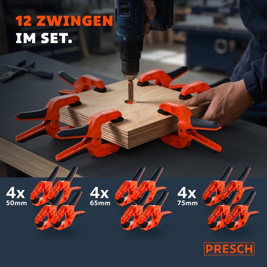 Twaalf veerklampen in drie maten omringen een houten plank, waar in het midden recht wordt geboord.