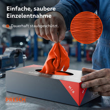 Het pakken van een oranje heavy-duty handschoen uit de stofdichte dispenserdoos in een werkplaats.