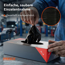 Verwijdering van een zwarte heavy-duty handschoen uit de stofdichte dispenserdoos in een werkplaatsomgeving.