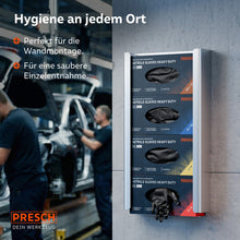 Wandgemonteerde metalen houder met vier dispensers voor zwarte heavy-duty nitrilhandschoenen in een garage voor schone afhaling.