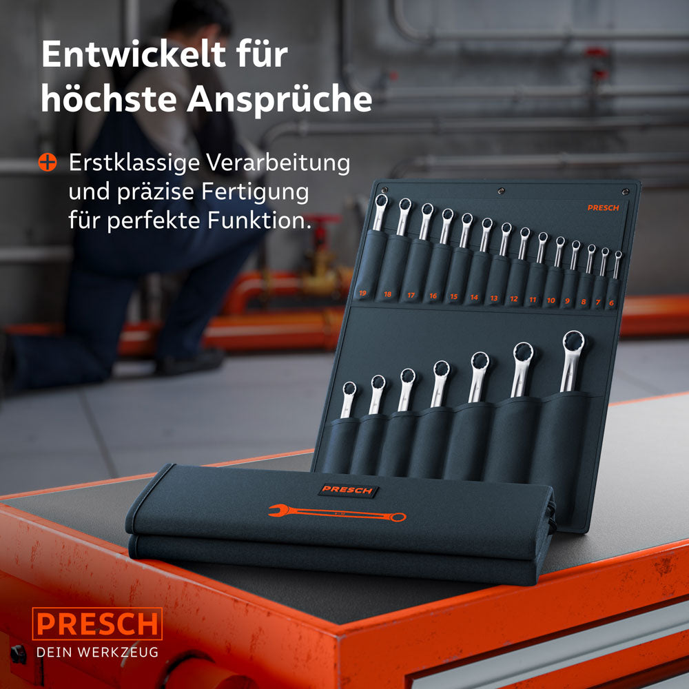 Die Rolltasche mit dem 21-teiligen Profi-Set liegt auf einem Werkstattwagen. Im Hintergrund arbeitet ein Mechaniker an Industrieanlagen, was die Eignung für professionelle Werkstatt- und Montagearbeiten betont.
