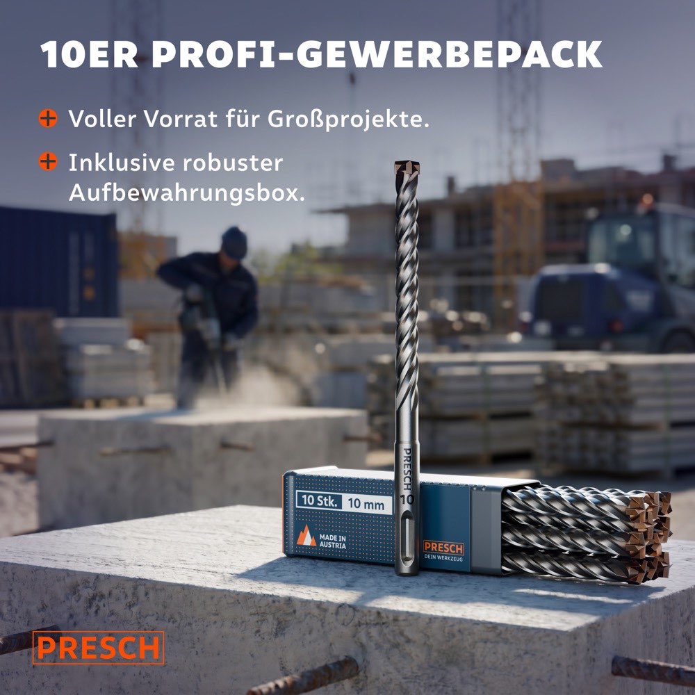 Ein SDS-Plus Hammerbohrer steht aufrecht auf der Aufbewahrungsbox für 10 Stück, im Hintergrund arbeitet ein Handwerker auf einer Großbaustelle