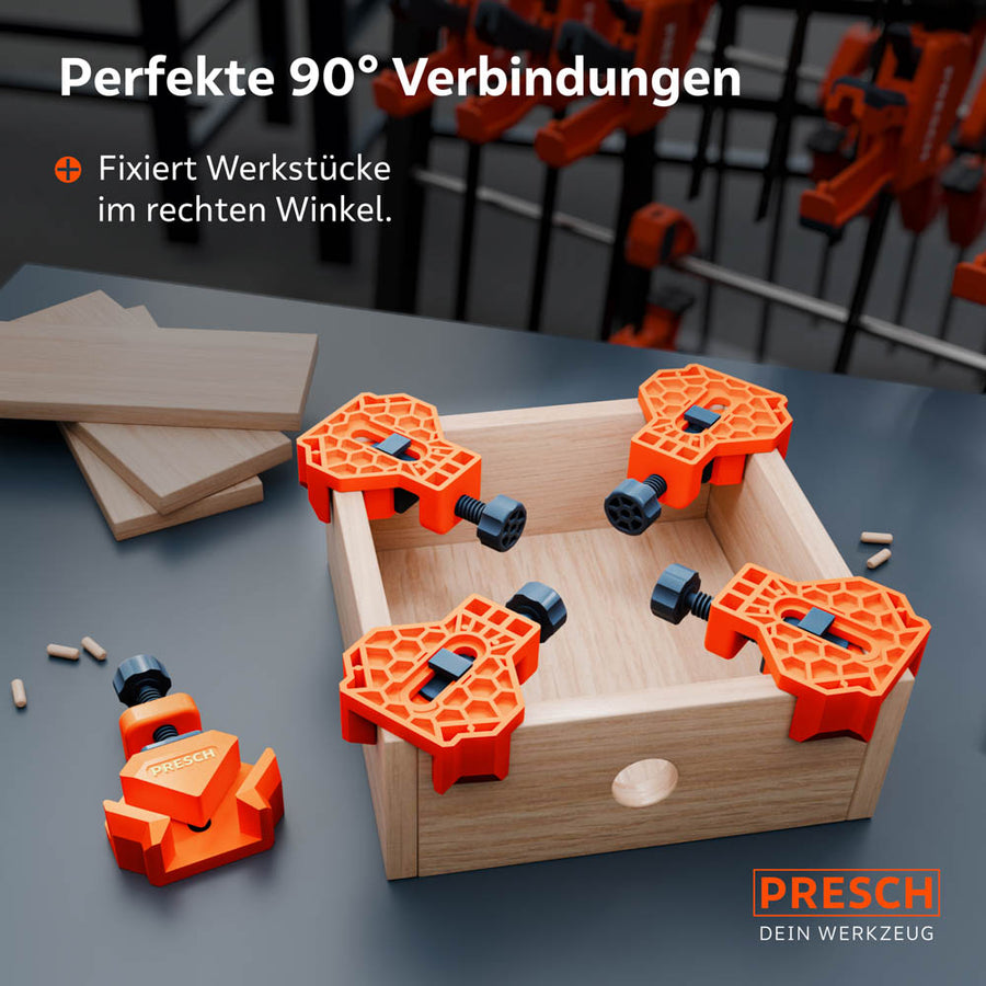 Anwendungsbeispiel: Vier Winkelspanner fixieren gleichzeitig die Ecken einer kleinen Holzbox im rechten Winkel. Das Bild zeigt, wie die Spanner Werkstücke präzise für die Montage positionieren.
