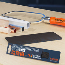 Universal Sägeblatt von PRESCH auf Arbeitsplatte neben weiteren Handwerkzeugen, Zugsäge und Metallsägeblatt als Zubehör.